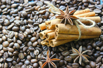 Cinnamon sticks and coffee beans closeup. Aromatic coffee - coffee beans and cinnamon sticks. Background. Copy space.