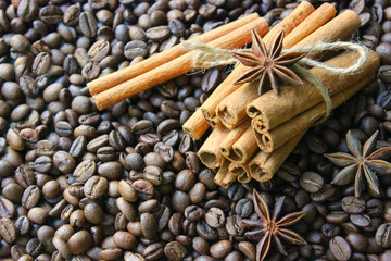 Cinnamon sticks and coffee beans closeup. Aromatic coffee - coffee beans and cinnamon sticks. Background. Copy space.