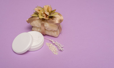 Fototapeta na wymiar beauty set with soap on a violet background