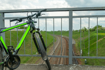 Bicycle stands on the bridge over the railway, top view. Tourism concept