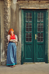 woman in skirt near a old building