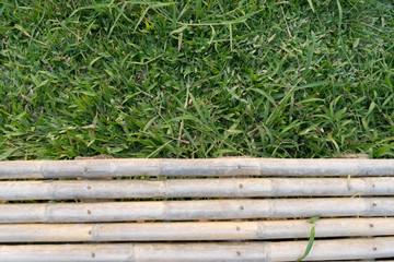 Bamboo balcony and green natural grass field 