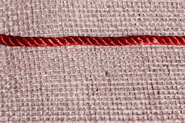 Red Thread On Fabric Background. Abstract Background Texture.