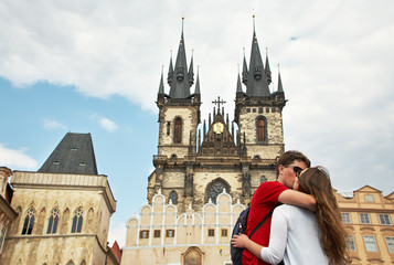 young couple travelers in love walking on a street of European city. sightseeing in Prague, Old...
