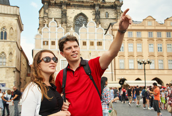 young couple travelers walking on a street of European city. sightseeing traveler. Prague, Old Town...