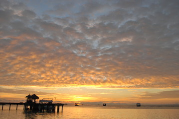 Colourful sunset on the island in Indian ocean with clouds boats ocean