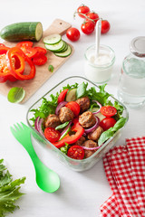 keto paleo lunch box with meatballs, lettuce, tomato, cucumber, bell pepper