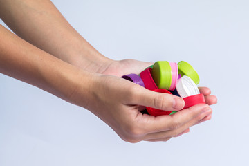 Girls holding plastic bottles caps for recycling to conserve the environment, on white background