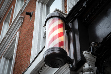 A barber's pole - sign used by barbers to signify the place or shop where they perform their craft