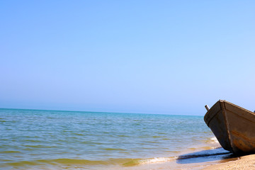 Fototapeta premium Fishing boat on the sand beach. Old boat on beach. 