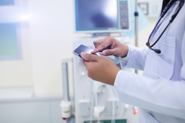 Side view of confident doctor in white medical uniform touching tablet with him finger at hospital,Medical industry concept.