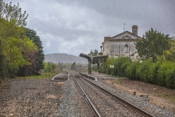 Fototapeta na wymiar View of train line, rainy day, Obidos train station as background