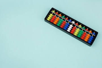 Abacus for mental arithmetic on a light blue background.