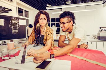 Young designer having a problem with measurements.