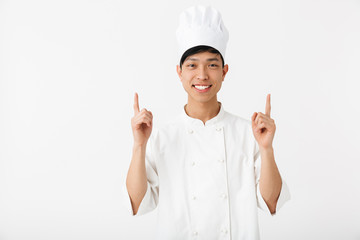 Excited asian chef wearing uniform standing