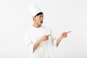 Excited asian chef wearing uniform standing