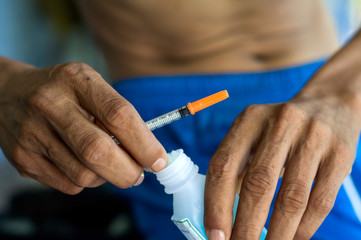 Diabetic patients are taking alcohol cotton To clean the skin before injecting sugar insulin with selective focus.