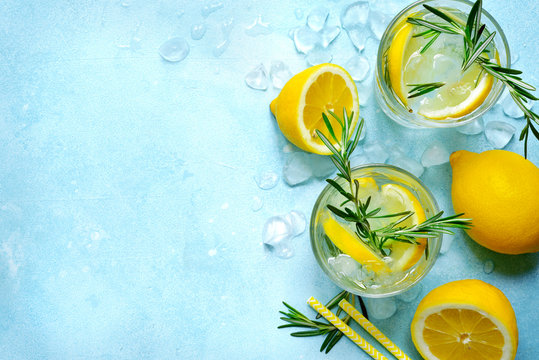 Summer citrus cocktail or lemonade with rosemary. Top view with copy space.