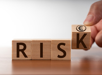  '' RISK '' written on block cubes. Euro symbol and economy concept