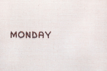 The word Monday written with coffee beans , aligned to the left.