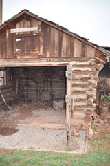Vintage log and sod roof barn and farm equipment and tools