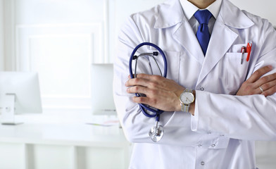 Medical content. Help. Medical doctor in white uniform with a stethoscope. Male practitioner....