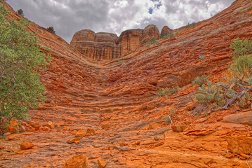 The north spire of Cathedral Rock in Sedona viewed from a dry sandstone waterfall that intersects the Templeton Trail.