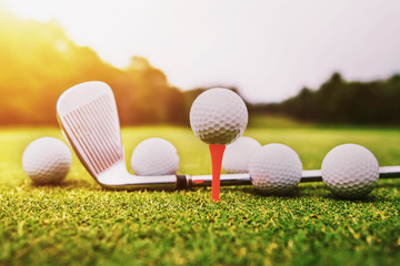 golf ball on green grass with sunset