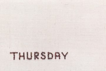 The word Thursday written with coffee beans , aligned at the bottom left.