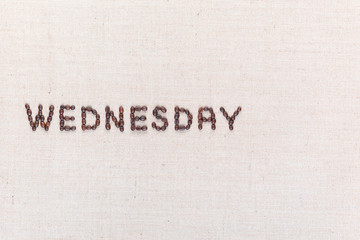 The word Wednesday written with coffee beans , aligned to the left.