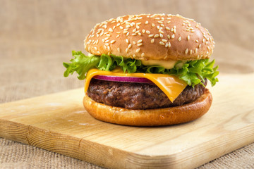 Homemade grilled cheese burger on wooden board