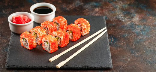 Japanese sushi on a rustic dark background.