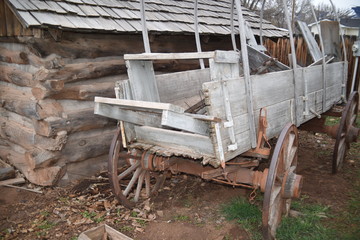Vintage log and sod roof barn and farm equipment and tools