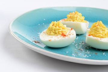 closeup deviled eggs on a blue plate