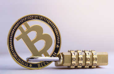 Bitcoin gold coin with padlock lying on white background..Bitcoin security. digital cyber safety or security encryption, Blockchain technology to encode online information or data protection.