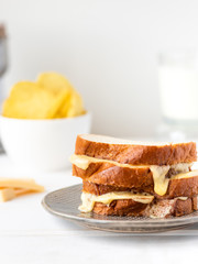Hot toast with cheese, delicious breakfast, sunny light background.