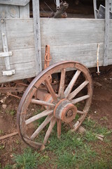 Fototapeta na wymiar Vintage log and sod roof barn and farm equipment and tools