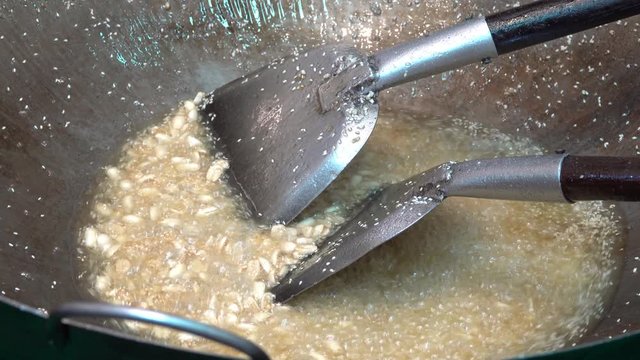 deep fried garlic in boiling oil in big pan