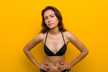 Obraz premium Young european woman wearing bikini scolding someone very angry.