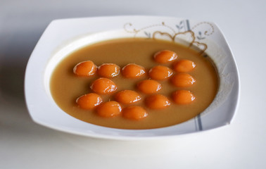 Biji salak on white background. Biji salak is sweet potato dumplings with coconut sauce. Popular dessert in Indonesia or to break the fast.