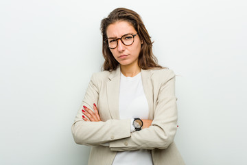Young european business woman unhappy looking in camera with sarcastic expression.