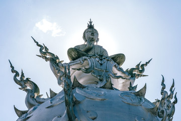 Fototapeta na wymiar Buddha Statue at the top of a Temple