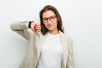 Young european business woman showing a dislike gesture, thumbs down. Disagreement concept.