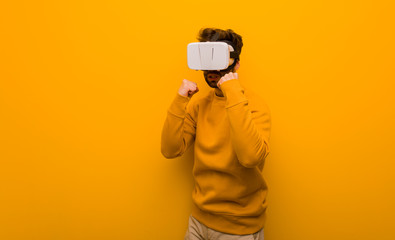 Fototapeta na wymiar Young man wearing a virtual reality glasses