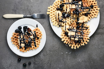 Waffles with chocolate, banana and berries.