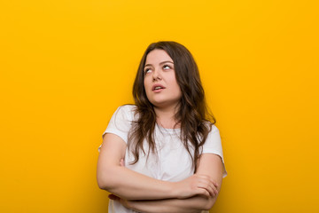 Obraz premium Young curvy plus size woman tired of a repetitive task.