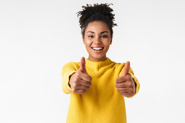Beautiful young african happy woman posing isolated over white wall background make thumbs up.