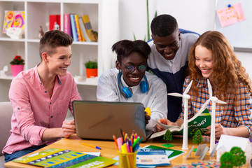 Fototapeta premium Cheerful teenagers feeling joyful while studying ecology together