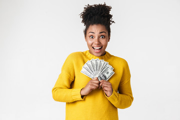African excited emotional happy woman posing isolated over white wall background holding money.