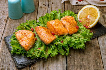 salmon fillet cooked on the grill on wooden background